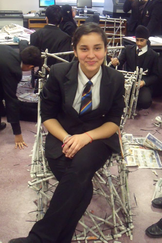 Student in paper chair