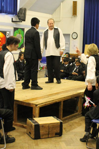 Student on stage with Globe Players